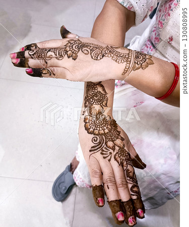 Picture of human hand being decorated with henna tattoo,Decorated Picture of human hand being decorated with henna tattoo,Decorated 130808995