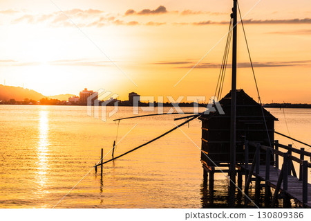 Evening view of Lake Togo - A lookout hut for four-hand net fishing Evening view of Lake Togo - A lookout hut for four-hand net fishing 130809386