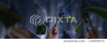 Solomon flags in their hands on a blurred urban background 130809473