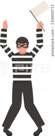 a thief in striped shirt and mask standing with raised arms holding a white flag symbolizing surrender caught during a crime scene 130809713
