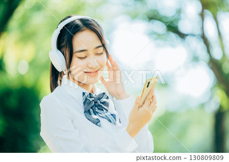 female student listening to music female student listening to music 130809809