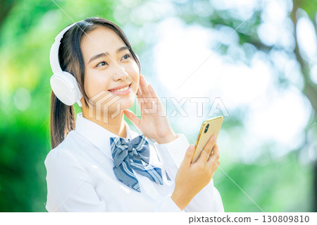 female student listening to music female student listening to music 130809810