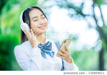 female student listening to music female student listening to music 130809811