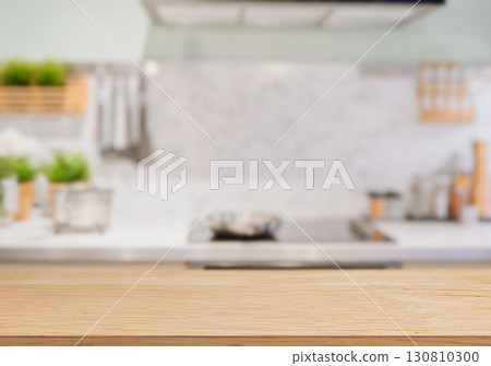 Wooden kitchen table with blurred modern background for mockup 130810300