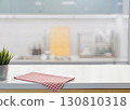 Modern kitchen counter with red checkered cloth and blurred background 130810318