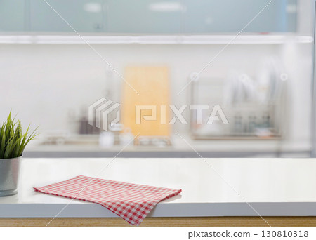 Modern kitchen counter with red checkered cloth and blurred background 130810318