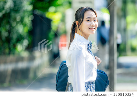 High school students waiting for the bus at the bus stop High school students waiting for the bus at the bus stop 130810324