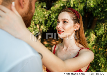 Romantic young couple looking at each other outdoors 130810427
