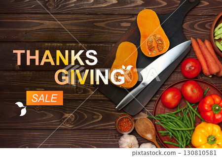 Thanksgiving sale features fresh vegetables and kitchen preparation tools on a wooden table 130810581