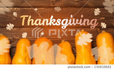 Celebrating Thanksgiving with decorative squash and autumn leaves on wooden background 130810682