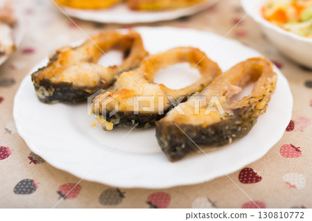 three pieces of fried carp on a white plate three pieces of fried carp on a white plate 130810772