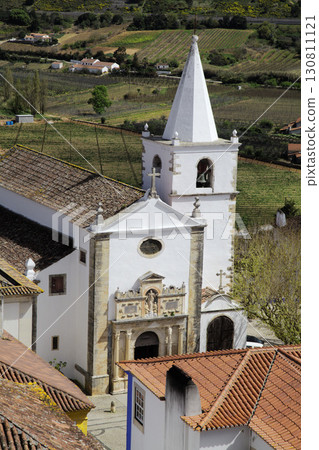 Church and rooftops in Obidos town, Portugal with scenic countryside view 130811121