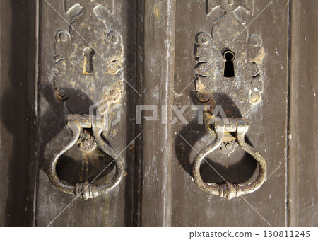 Door knockers at Monastery Santa Maria in Alcobaca, Portugal showcasing intricate design Door knockers at Monastery Santa Maria in Alcobaca, Portugal showcasing intricate design 130811245