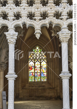 Beautiful Gothic architecture of Batalha Monastery in Portugal with vibrant stained glass window 130811315