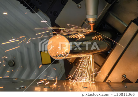 Close up scene the fiber laser cutting machine cut the stainless steel tube control by CNC program. Close up scene the fiber laser cutting machine cut the stainless steel tube control by CNC program. 130811366