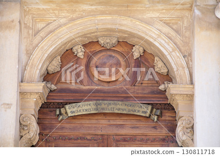 Intricate wooden door with historical inscription in Coimbra Portugal Intricate wooden door with historical inscription in Coimbra Portugal 130811718