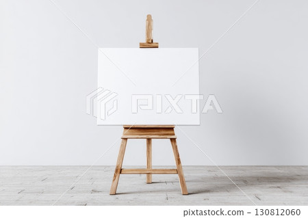 Blank white canvas on an easel on a wooden stand, a mock-up on a neutral background. Empty space for text or design. Web banner. Landscape artist easel painter, stand, frame. Sign Painting Mockup 130812060