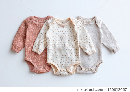 Baby onesie set on a light background. Fashion newborn clothes. Flat lay, top view. Baby kids soft clothing made from organic cotton. Infant trendy bodysuit natural colors, earth tones. Gender neutral 130812067