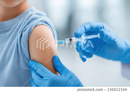 Child receiving a vaccination. Little boy in face mask in doctor's office is vaccinated. Kid giving injection shot. Syringe with covid-19, coronavirus, flu vaccine. Dangerous infectious disease, MPOX 130812104