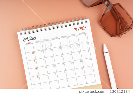 2026 October desk calendar with brown sunglasses. Directly above. Calendar and reminder concept. 130812184