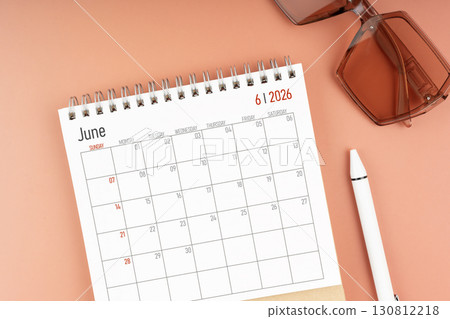 2026 June desk calendar with brown sunglasses. Directly above. Calendar and reminder concept. 130812218