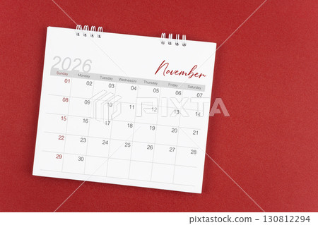 November 2026 desk calendar on red background. Page of annual monthly calendar for plan. 130812294
