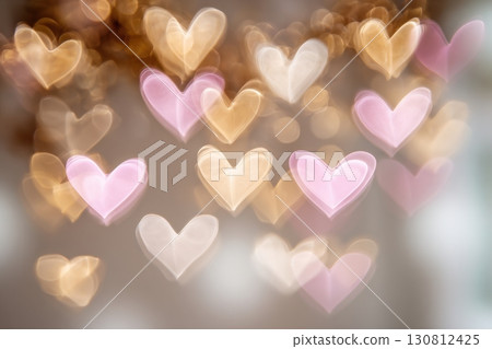 Defocused pink and golden heart shaped bokeh light. Abstract grey gradient background hearts bokeh. Holiday, Valentines Day backdrop. Ideal to layer design. Glowing Hearts Festive overlay effect 130812425