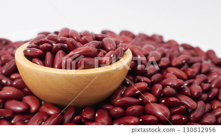 Raw Red Kidney Beans in Wooden Bowl on Pile of Beans Background 130812956