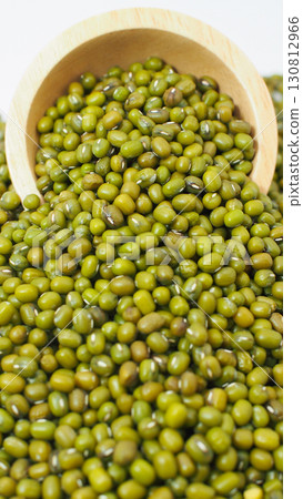 Mung beans spilling from wooden bowl on white background 130812966