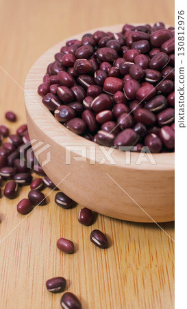Adzuki beans in wooden bowl on wooden surface Adzuki beans in wooden bowl on wooden surface 130812976