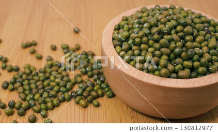 Mung beans in wooden bowl on wooden surfaceMung beans in wooden bowl on wooden surface Mung beans in wooden bowl on wooden surfaceMung beans in wooden bowl on wooden surface 130812977