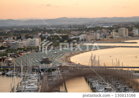 Seaport of Italian city of Rimini. Wide sandy sea beach resort with sun loungers and umbrellas on coast top view. Hotels apartments 130813166