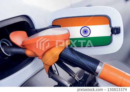 The flag of the Kingdom of India on the lid of the gas tank of a car at a gas station in close-up. High or low gasoline prices at Indian gas stations. In India, gasoline prices are rising due to a 130813374