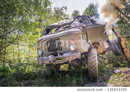 Smoke is coming from a damaged military truck, a drone attack, or Military truck engulfed in smoke after explosive attack during ongoing conflict in Ukraine. Smoke is coming from a damaged military truck, a drone attack, or Military truck engulfed in smoke after explosive attack during ongoing conflict in Ukraine. 130813395