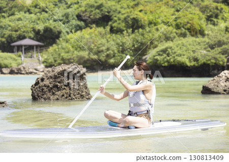 Cute woman enjoying SUP 130813409