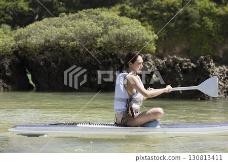 Cute woman enjoying SUP 130813411