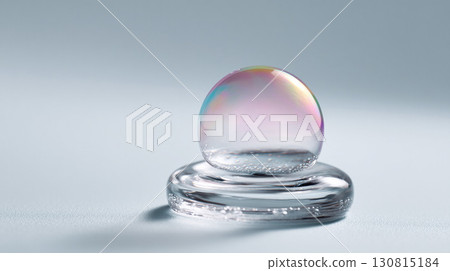 A delicate, iridescent water drop on clear glass. A metaphor for fragility, purity, or innovation. Ideal for science, technology, beauty, or conceptual themes. 130815184