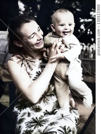 Vintage portrait of happy mother and son. Mother holds son in her arms and both smile. Retro photo from 1966. USSR. 130815866
