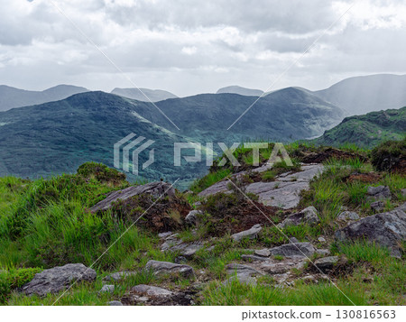 Majestic mountain range in Ireland. A stunning vista of verdant hills and valleys under a dramatic sky. Ideal for travel brochures. Majestic mountain range in Ireland. A stunning vista of verdant hills and valleys under a dramatic sky. Ideal for travel brochures. 130816563