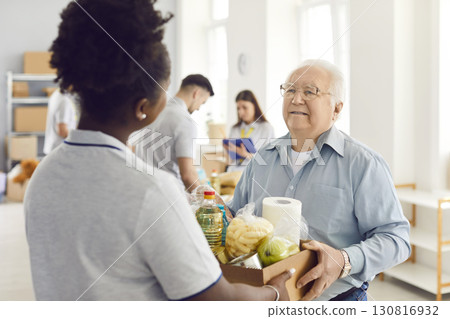 Giving help, young volunteer group working in charitable food foundation, make donation to old needy Giving help, young volunteer group working in charitable food foundation, make donation to old needy 130816932