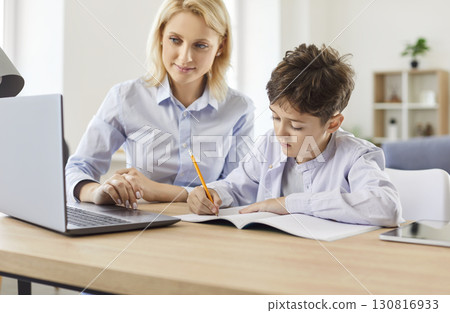 Mother Helping Son With Homework And Online Learning At Home Mother Helping Son With Homework And Online Learning At Home 130816933