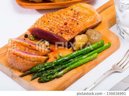 Duck breast with baked onions and asparagus 130816991