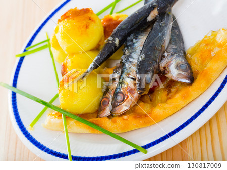 Dish of tasty fried anchovy with potato croquettes and cake served 130817009