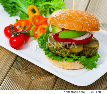 Vegetarian hamburger with soybean cutlet, tomato, avocado and lettuce 130817016
