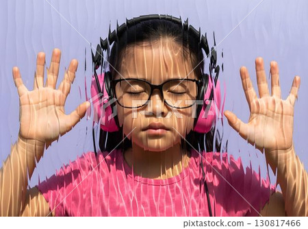 Neurodivergent kid asian girl with pink headphones pressing hands to textured glass, eyes closed, symbolic image of autism, sensory hypersensitivity and isolation Neurodivergent kid asian girl with pink headphones pressing hands to textured glass, eyes closed, symbolic image of autism, sensory hypersensitivity and isolation 130817466