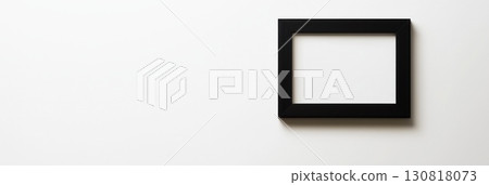 empty black frame hanging on white wall minimalist interior decor copyspace modern clean concept of art gallery branding exhibition 130818073