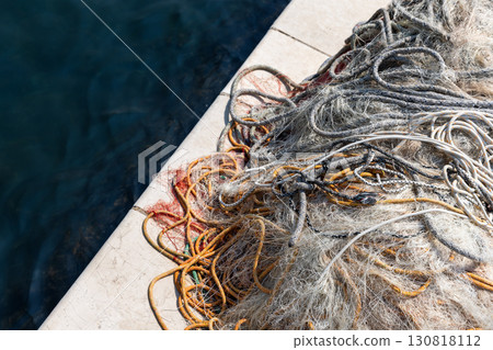 A close-up view of a colorful, tangled fishing net, top view 130818112
