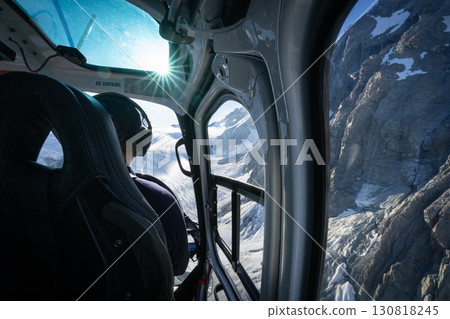 Over the pilot shoulder view from helicopter flying above alpine glacial terrain, New Zealand Over the pilot shoulder view from helicopter flying above alpine glacial terrain, New Zealand 130818245