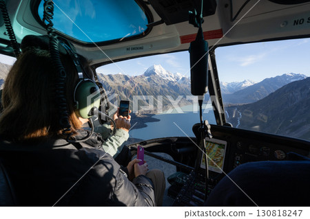 Passengers enjoying view on alpine landscape with mountains during helicopter flight, New Zealand Passengers enjoying view on alpine landscape with mountains during helicopter flight, New Zealand 130818247