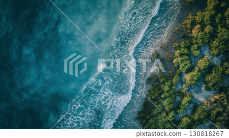 Aerial view blue ocean waves crashing lush green coastline sunny day 130818267